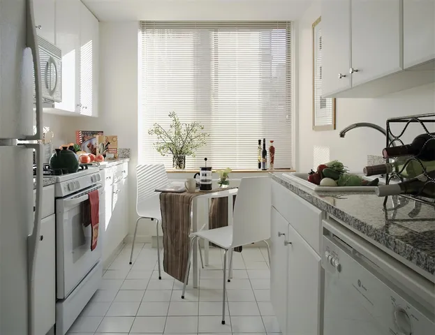 a kitchen with a sink cabinets and appliances