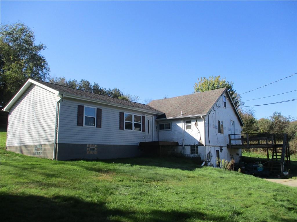 156 Doyle Road Sarver, PA 16055 - Photo 1 of 25 a brick house that is sitting in front of a house with a big yard