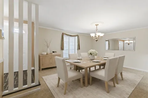 a view of a dining room with furniture and window