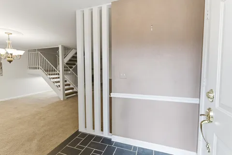 a view of a hallway with stairs