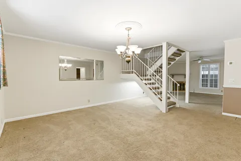 en view interior of a house with wooden floor windows and stairs