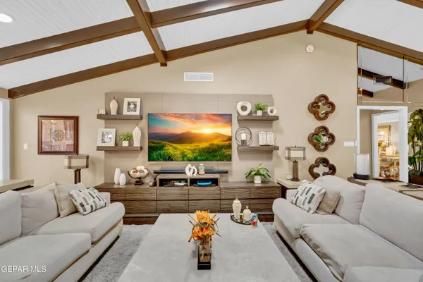 a living room with furniture and a flat screen tv