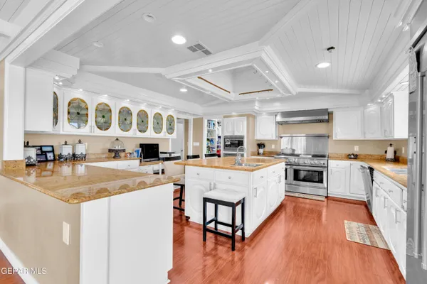 a living room with furniture and kitchen view