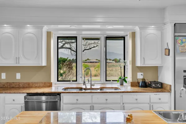 a kitchen with stainless steel appliances a refrigerator and a sink