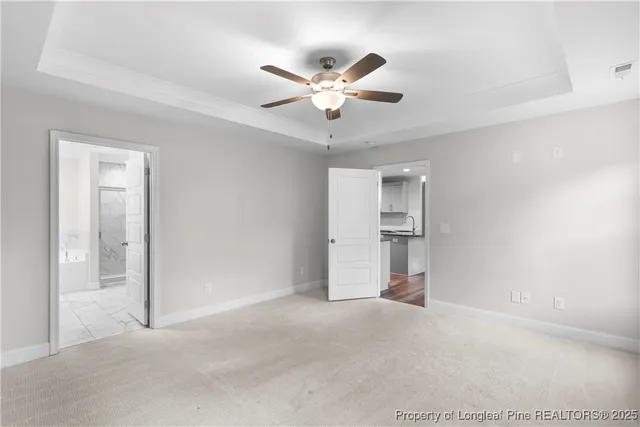 a view of an empty room with a ceiling fan