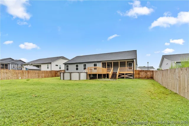 a view of a house with a big yard and large trees