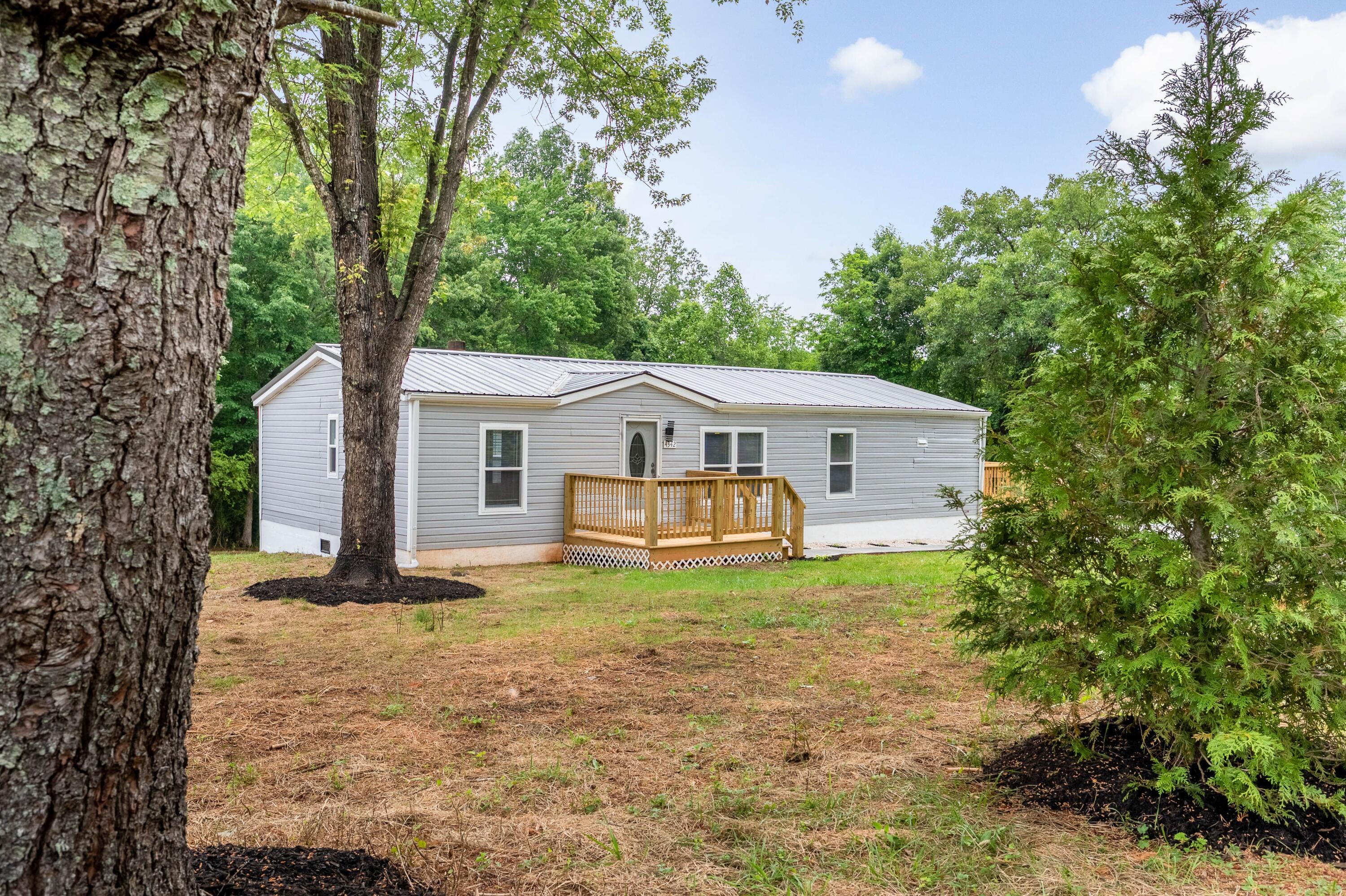 4342 County Line Road Patrick Springs, VA 24133 - Photo 1 of 34 a view of a house with a big yard and large tree