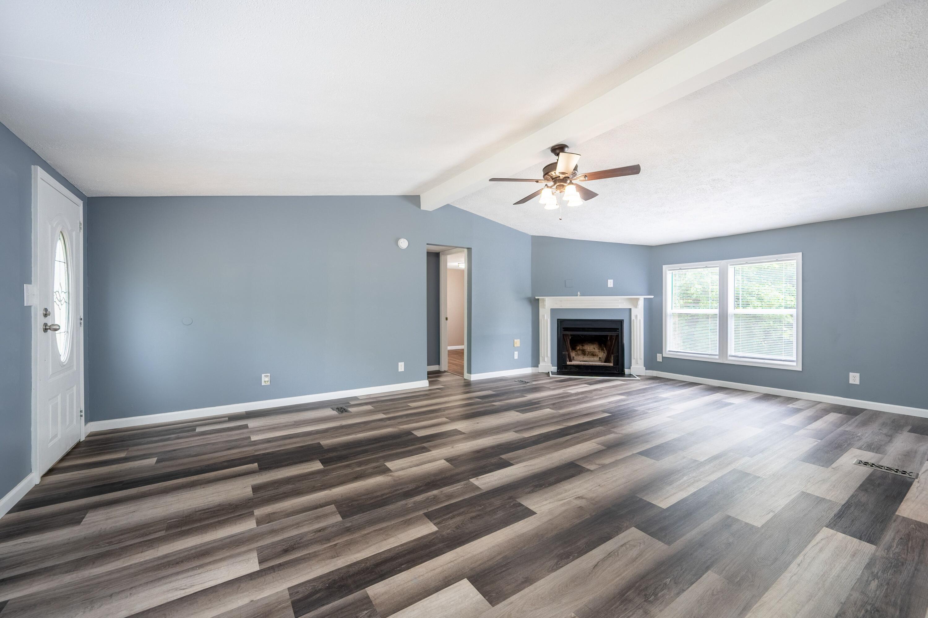 4342 County Line Road Patrick Springs, VA 24133 - Photo 16 of 34 a view of an empty room with a fireplace and a window