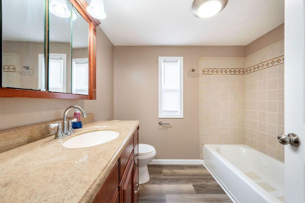 4342 County Line Road Patrick Springs, VA 24133 - Photo 24 of 34 a bathroom with a granite countertop tub sink and mirror