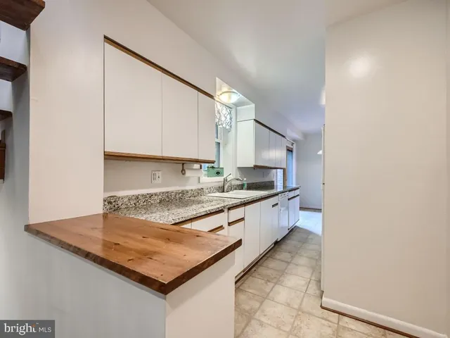 a view of a kitchen with furniture and entryway