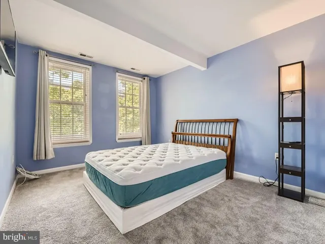 a bathroom with a granite countertop sink a toilet a mirror and shower