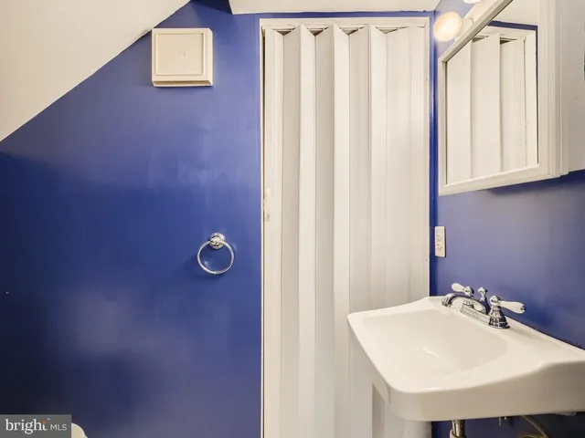 a bathroom with a sink a mirror and a vanity