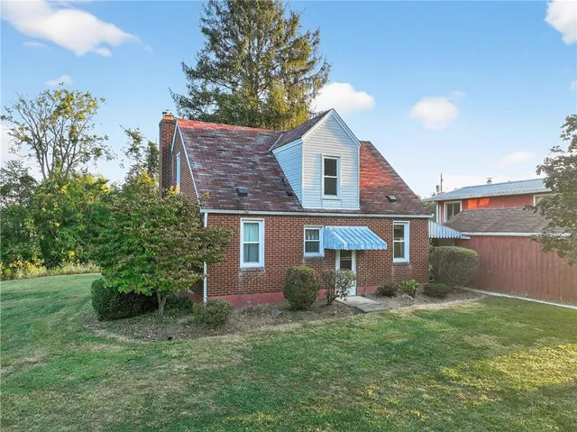 a house view with swimming pool in front of it