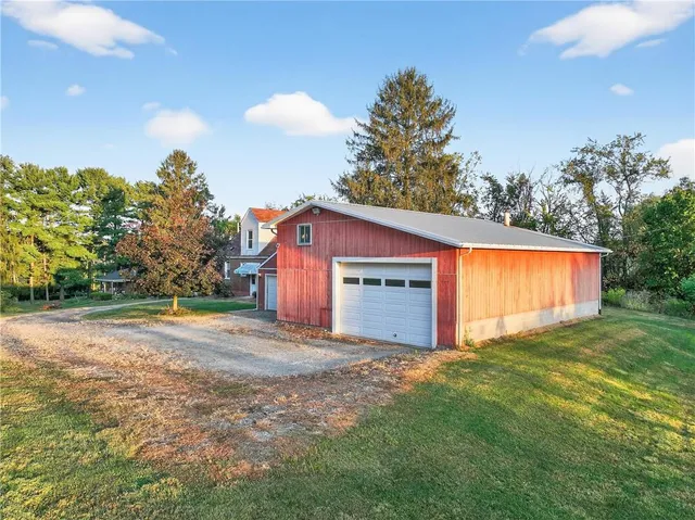 a view of a house with a yard and swimming pool