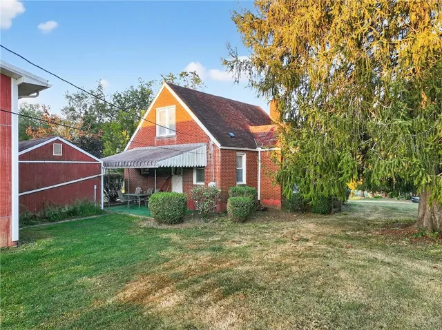 a front view of a house with a garden