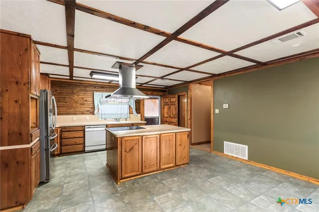 a kitchen with a stove and a refrigerator
