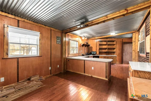 a room with a chair and wooden floors