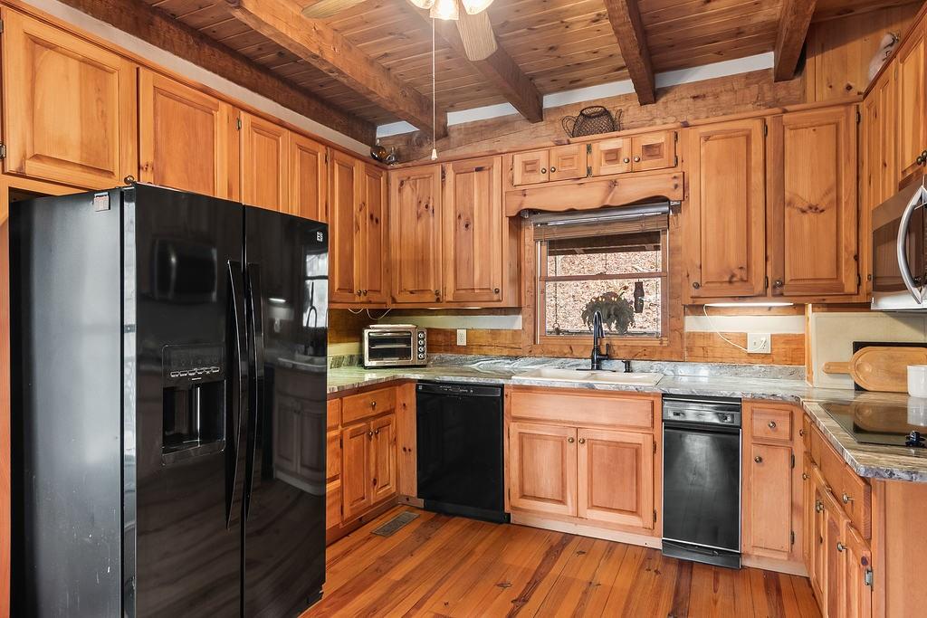 192 Grassy Knob Court Jasper, GA 30143 - Photo 33 of 88 a kitchen with stainless steel appliances granite countertop a refrigerator a sink dishwasher a stove and white cabinets with wooden floor