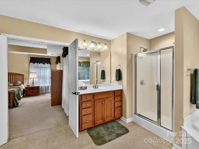 a large bathroom with a double vanity sink a large mirror and a shower