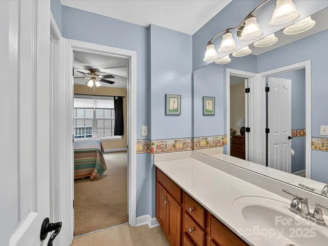 a bathroom with a sink a vanity and a mirror