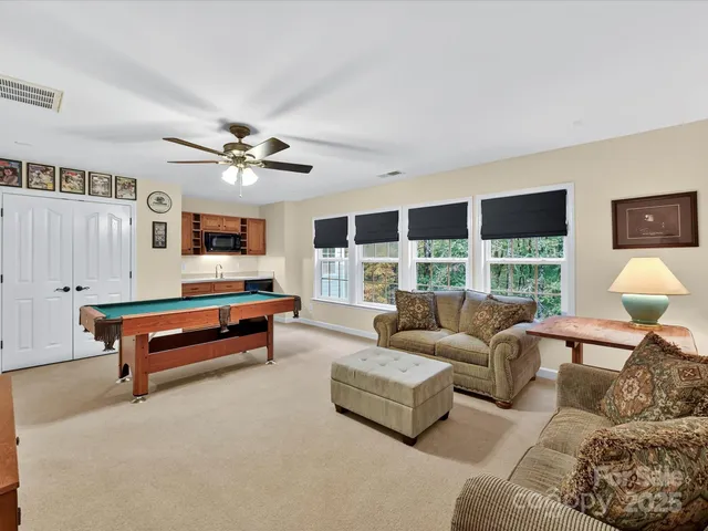 a living room with furniture and a floor to ceiling window