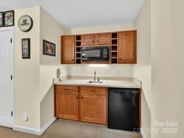 a kitchen with stainless steel appliances a sink and a microwave