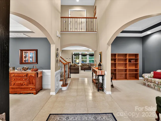 a view of a livingroom with furniture and staircase