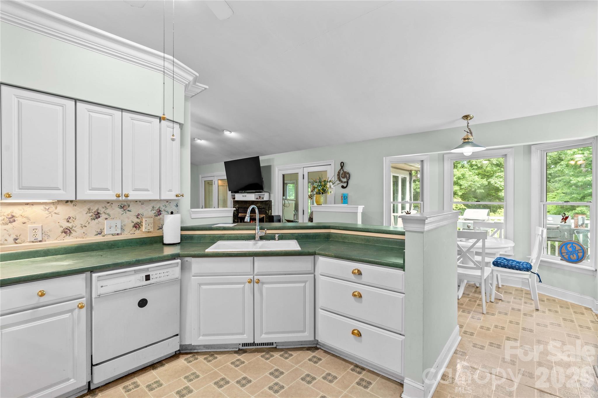 711 Spring Pointe Drive Stony Point, NC 28678 - Photo 18 of 47 a kitchen with white cabinets and sink