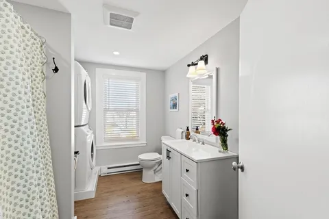 a bathroom with a sink mirror and a bathtub