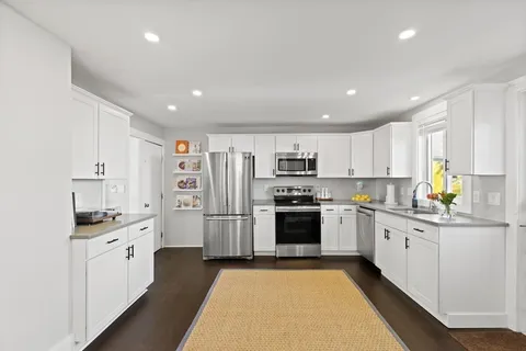 a kitchen with stainless steel appliances a refrigerator sink and cabinets