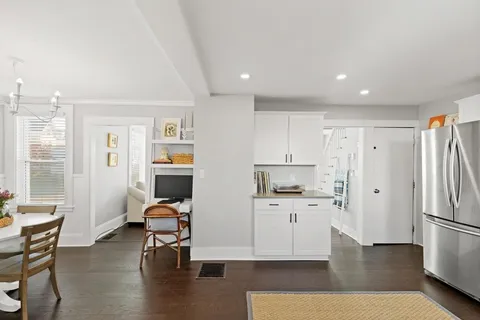 a view of a kitchen with furniture and wooden floor