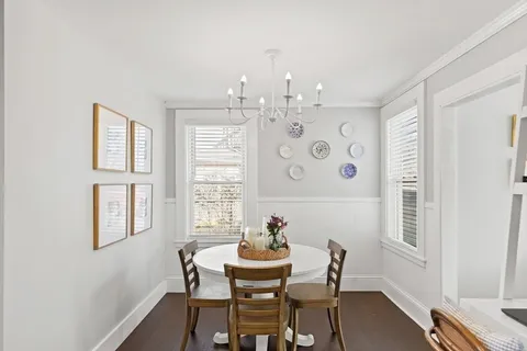 a view of a dining room with furniture window and wooden floor