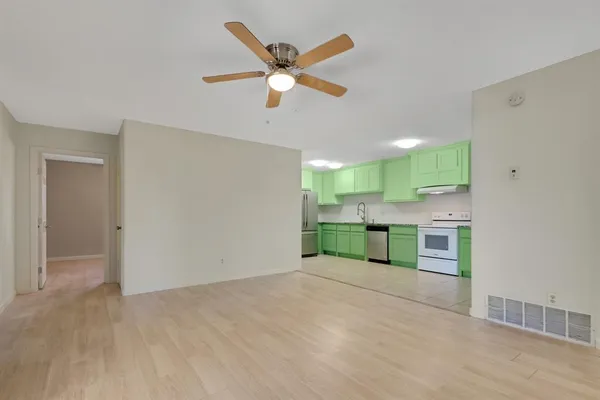 a view of a kitchen with a sink and a ceiling fan