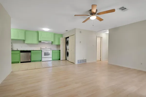 a view of kitchen with a sink cabinets and window