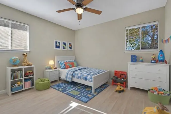 a bedroom with a bed and a window