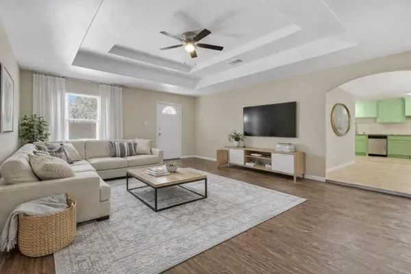 a living room with furniture and a flat screen tv