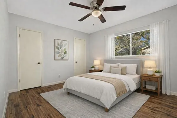 a bedroom with a large bed and a window