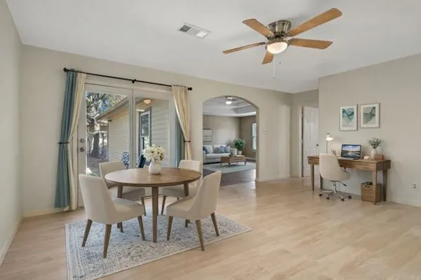 a view of a dining room with furniture and a large window