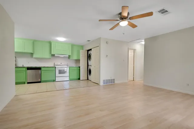 a view of kitchen with a sink cabinets and window