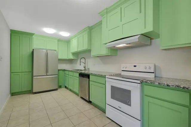 a kitchen with a cabinets and a stove top oven