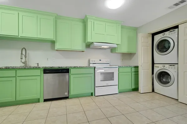a kitchen with a sink a stove top oven and cabinets