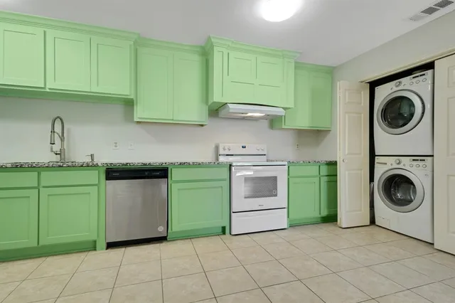 a kitchen with a sink a stove top oven and cabinets