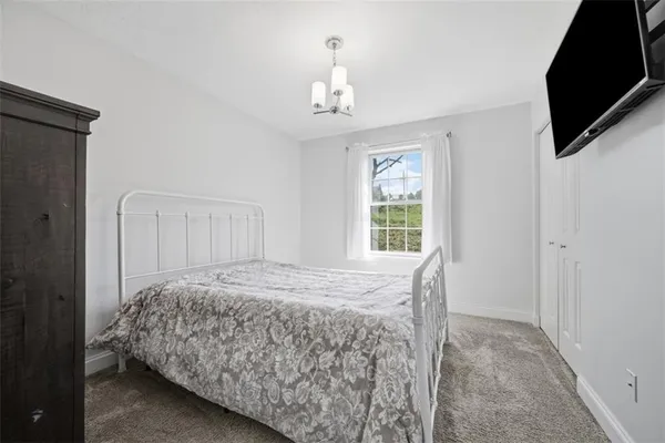 a bedroom with a bed and a television