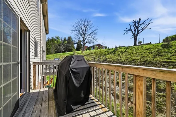 a balcony with wooden floor and fence