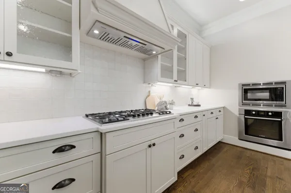 a kitchen with granite countertop cabinets and steel stainless steel appliances