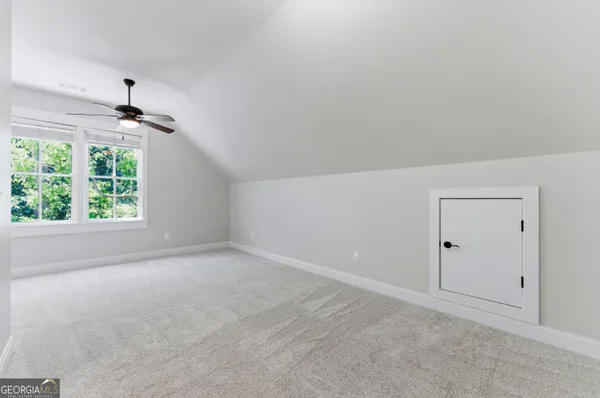 an empty room with windows and closet