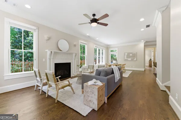 a living room with furniture a fireplace and a large window