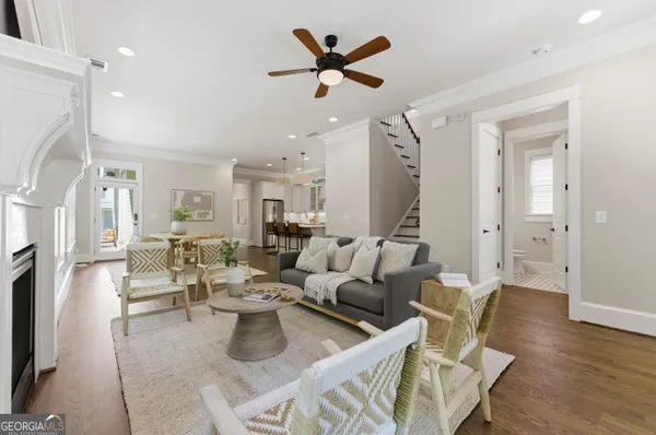 a living room with furniture a fireplace and a chandelier