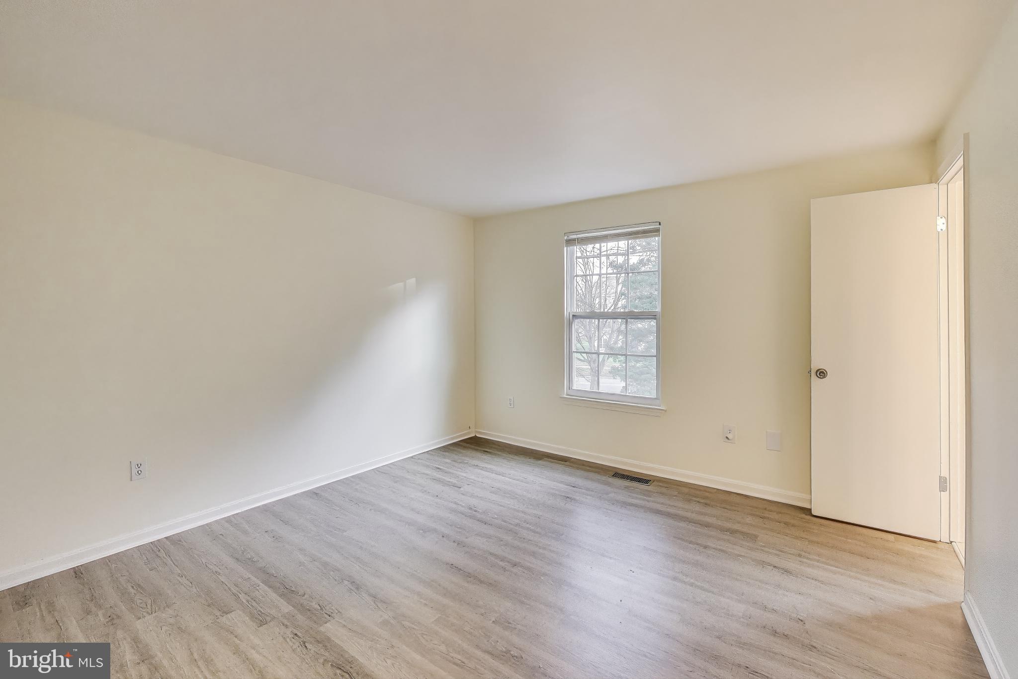 16 Tabiona Court Silver Spring, MD 20906 - Photo 14 of 34 an empty room with wooden floor and windows