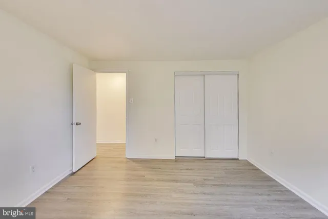 a view of an empty room and wooden floor